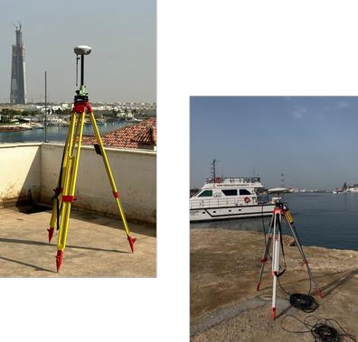 Two GNSS bases on tripods at the waterfront